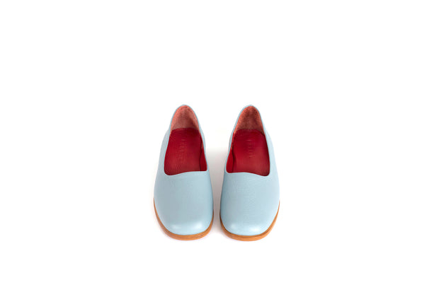 Front view of light blue flat leather shoes