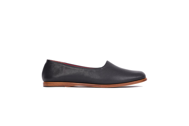 Side view of black flat leather shoes