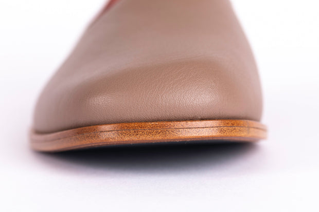 Detail shot of taupe flat leather shoes
