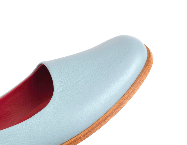 Detail shot of light blue flat leather shoes