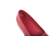 Detail shot of red flat leather shoes