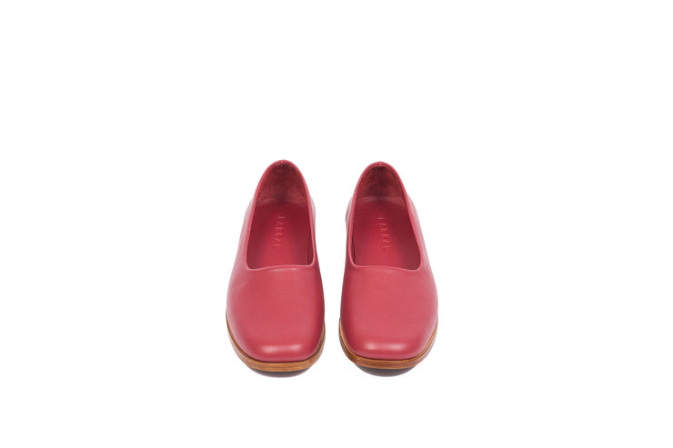 Front view of red flat leather shoes
