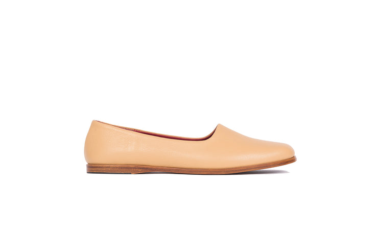 Side view of tan flat leather shoes