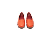 Front view of orange flat leather shoes