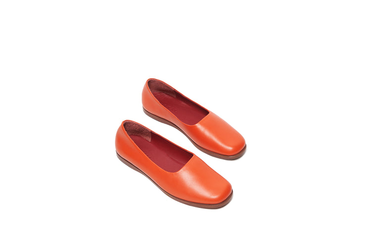 Top view of orange flat leather shoes