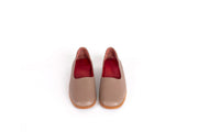 Front view of taupe flat leather shoes