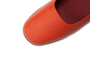Detail shot of orange flat leather shoes