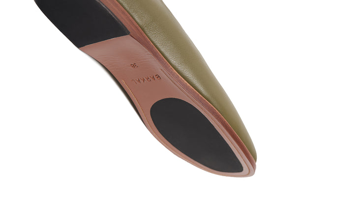 Detail shot of olive green flat leather shoes